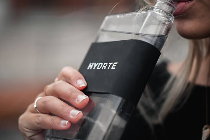 holding bottle of water